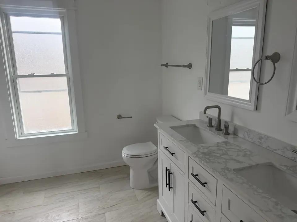Bathroom and tile renovations: Bathroom renovation progress, tile installation, and finished fixtures.