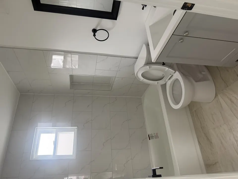 Bathroom and tile renovations: Bathroom renovation progress, tile installation, and finished fixtures.