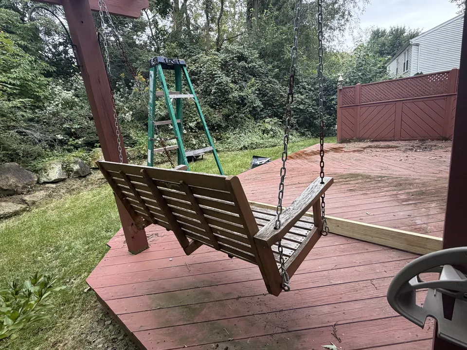 Weathered deck boards and swing before refinishing