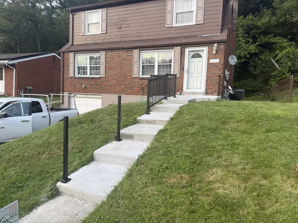 Black railings beside the entry steps