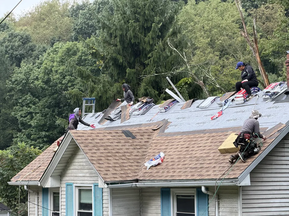 Crew installing shingles on the roof